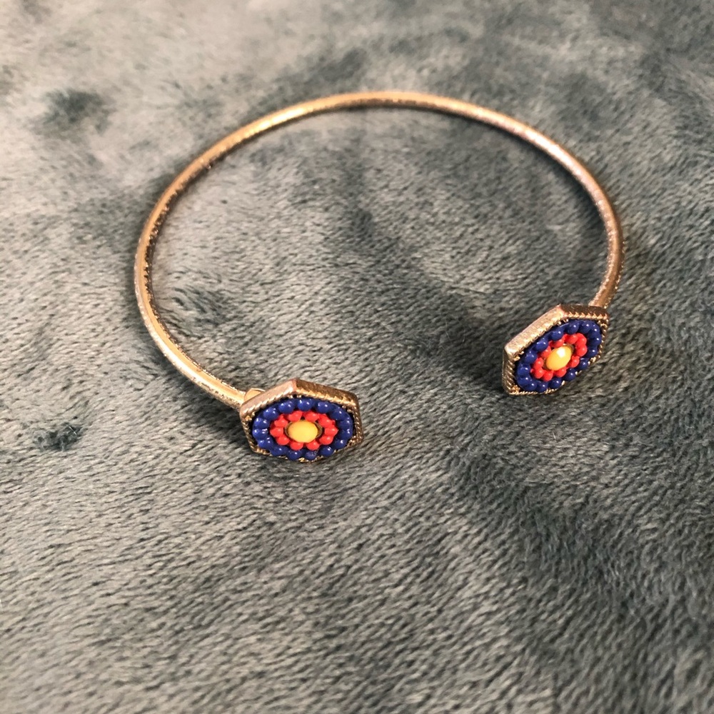 Gold cuff with blue yellow and red beading
